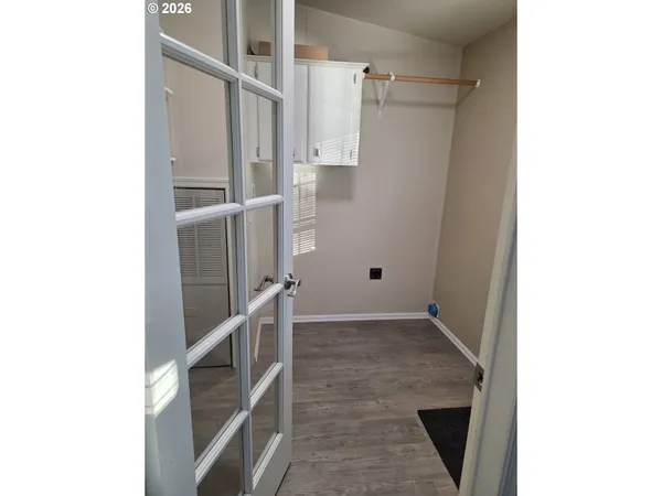 a view of empty room with wooden floor