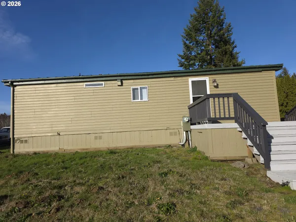 a view of a house with a yard and garage