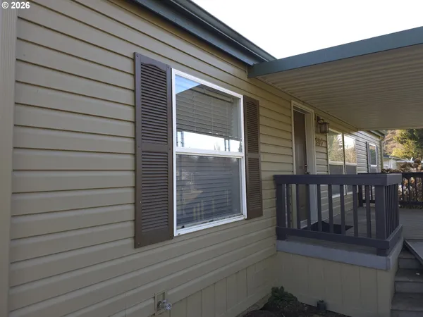 a view of a porch with wooden floor and stairs