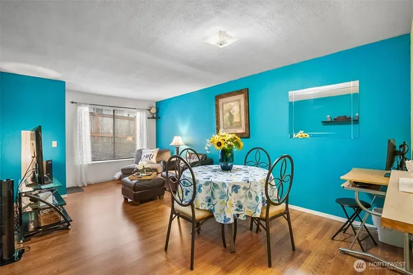 a view of a dining room with furniture window and wooden floor