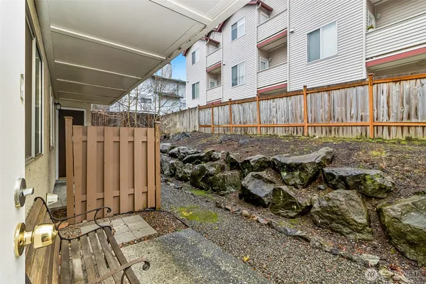 a view of a house with a wooden fence