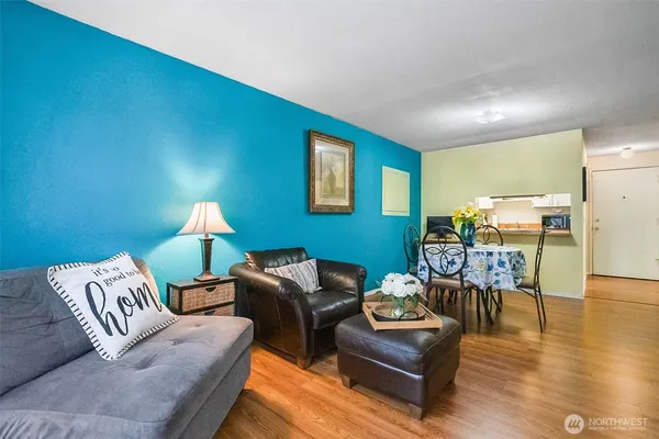 a living room with furniture and wooden floor