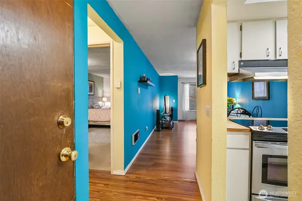a view of a hallway with wooden floor windows and livingroom