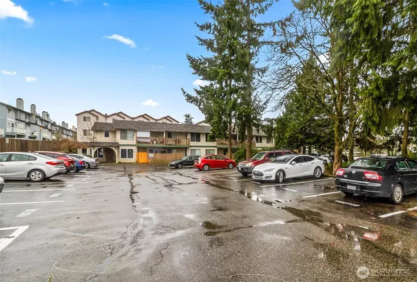 a view of cars parked in front of a house