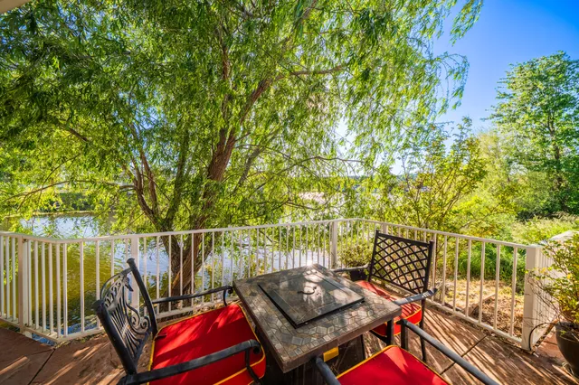 a view of an house with backyard and furniture