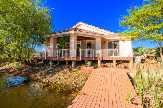 a view of a house with swimming pool next to a yard