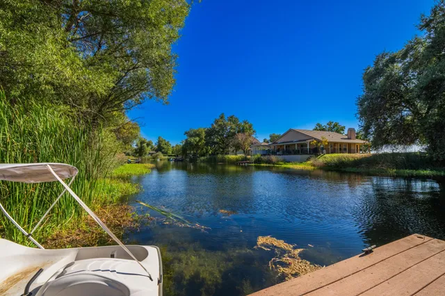 a view of residential houses with outdoor space and lake view