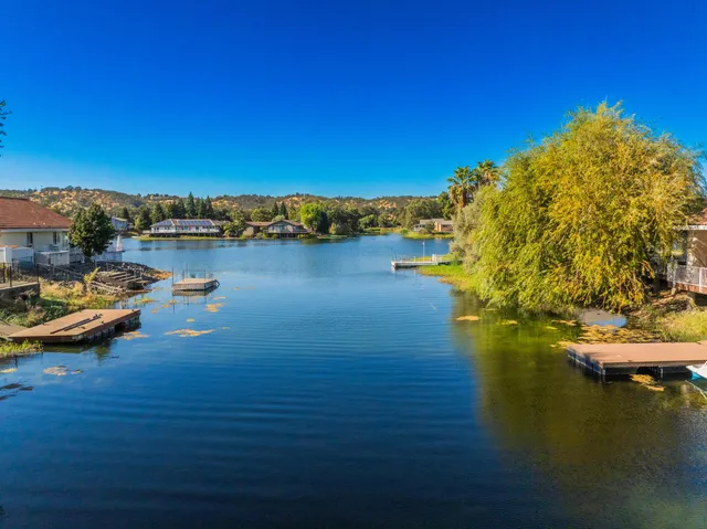 an aerial view of ocean and residential houses with outdoor space