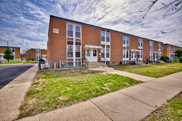 a front view of building with yard
