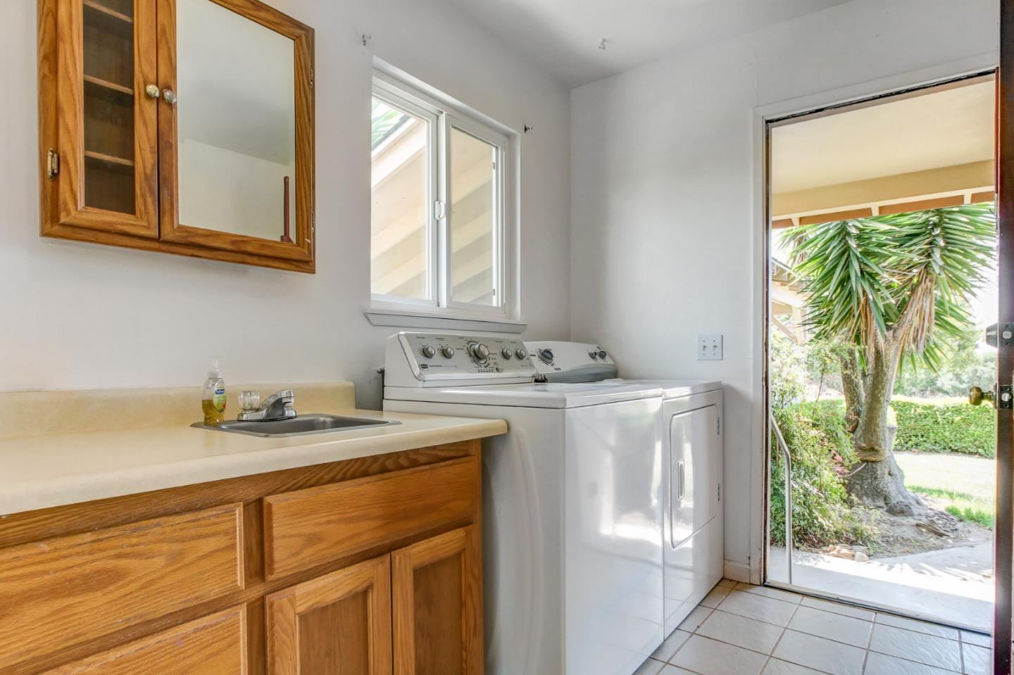 85 Kerr Road Watsonville, CA 95076 - Photo 20 of 29 a bathroom with a granite countertop sink and a window