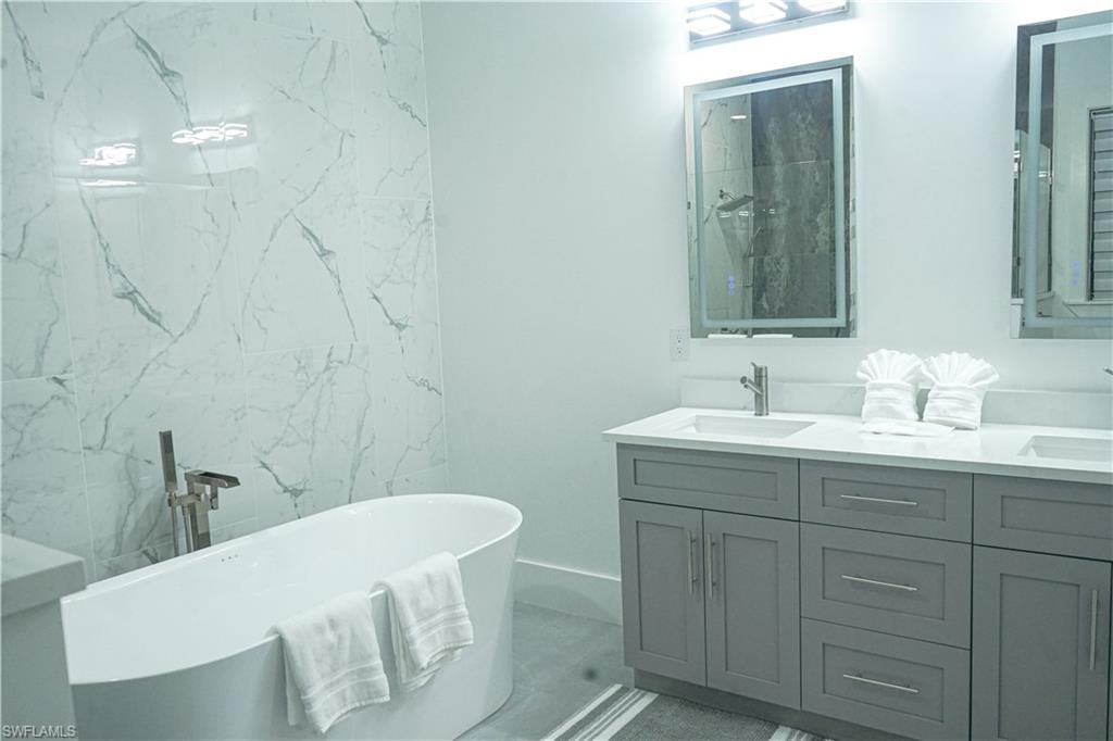 Undisclosed Address Naples, FL 34117 - Photo 12 of 23 a bathroom with a sink and a mirror