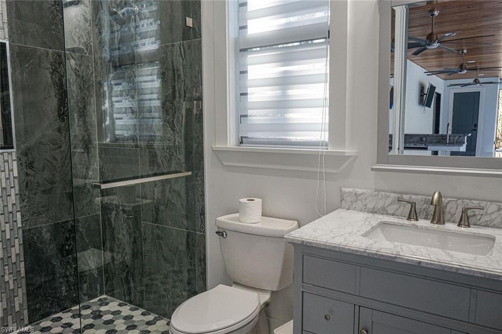Undisclosed Address Naples, FL 34117 - Photo 13 of 23 a bathroom with a sink a toilet and shower