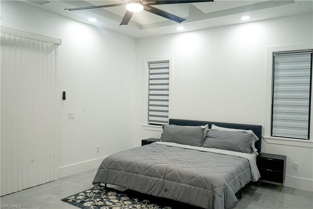 Undisclosed Address Naples, FL 34117 - Photo 15 of 23 a bedroom with a bed and a window