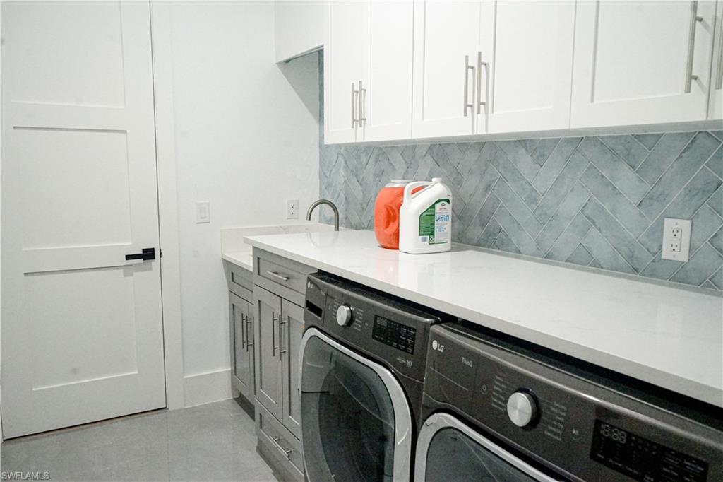 Undisclosed Address Naples, FL 34117 - Photo 16 of 23 a kitchen with a sink and cabinets