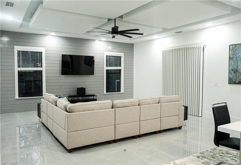 Undisclosed Address Naples, FL 34117 - Photo 17 of 23 a living room with furniture and a flat screen tv