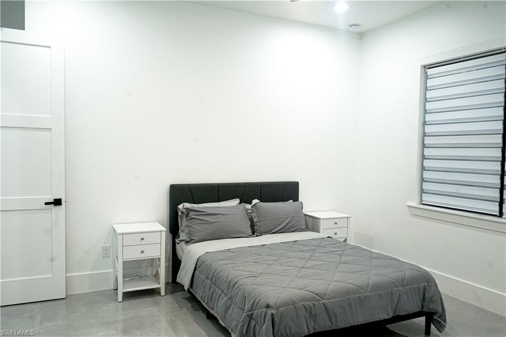 Undisclosed Address Naples, FL 34117 - Photo 18 of 23 a bedroom with a bed and cabinet