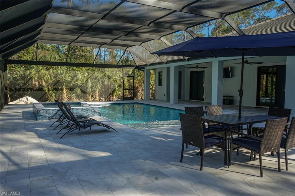 Undisclosed Address Naples, FL 34117 - Photo 6 of 23 a view of a porch with furniture