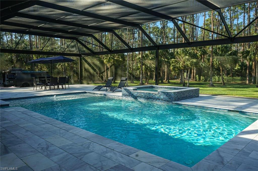 Undisclosed Address Naples, FL 34117 - Photo 7 of 23 a view of swimming pool with a yard