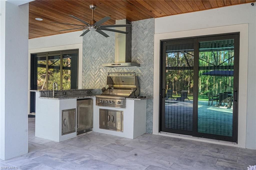 Undisclosed Address Naples, FL 34117 - Photo 8 of 23 a kitchen with stainless steel appliances granite countertop a stove and a refrigerator