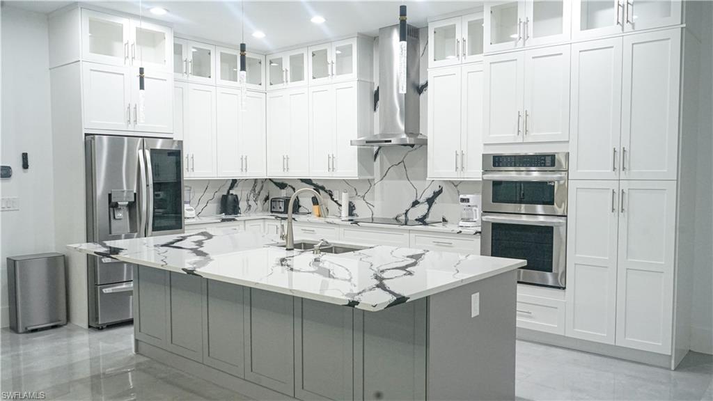 Undisclosed Address Naples, FL 34117 - Photo 10 of 23 a kitchen with a sink a stove and refrigerator