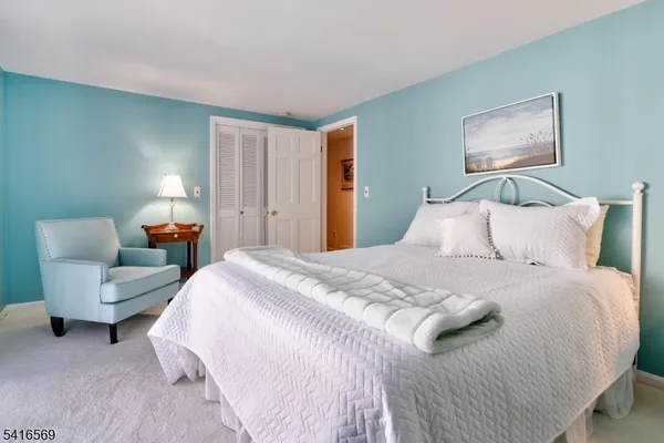 a bedroom with bed and a couch