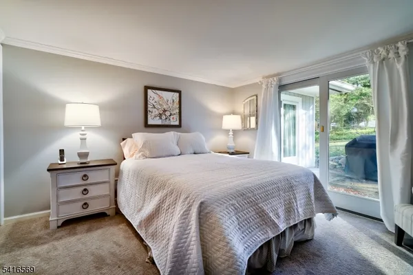 a spacious bedroom with a bed and large window