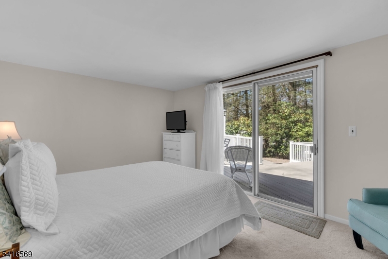 149 Lake End Road Newfoundland, NJ 07435 - Photo 24 of 49 a bedroom with a bed and a large window