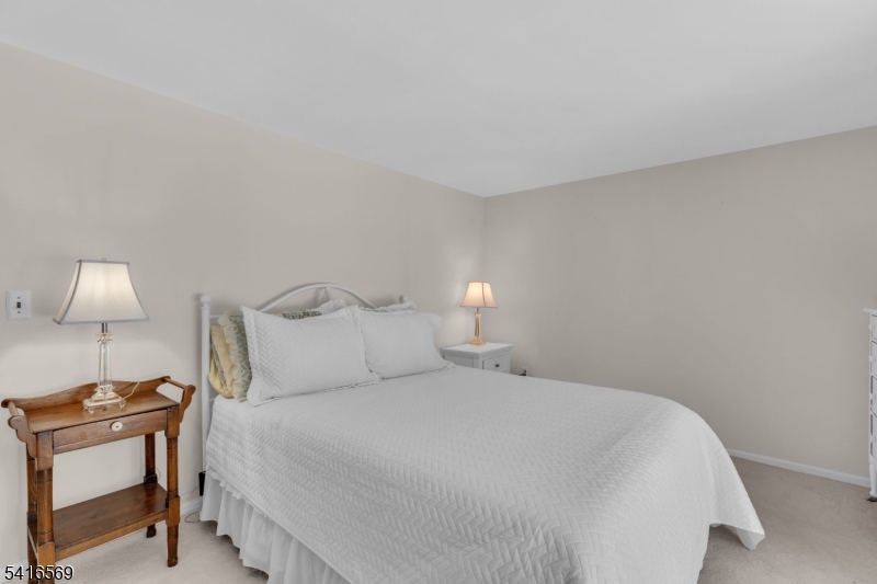 149 Lake End Road Newfoundland, NJ 07435 - Photo 25 of 49 a bedroom with a bed and a lamp on desk
