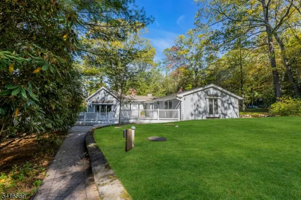 a front view of a house with yard and green space