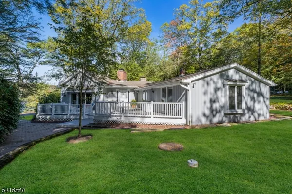 a view of a house with a yard and sitting area