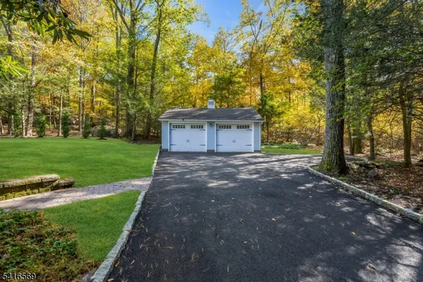 a view of a house with backyard and trees