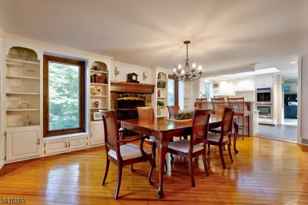 a dining room with furniture window and wooden floor