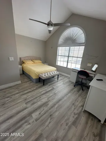 a bedroom with a bed and a chandelier