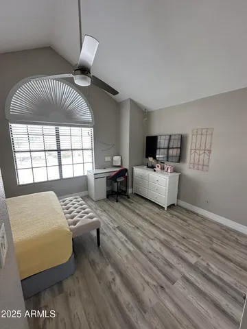 a bedroom with furniture and a large window