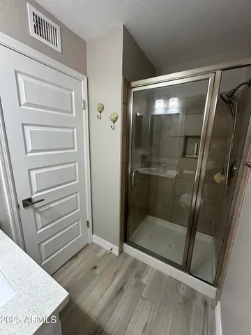 a bathroom with a shower and toilet