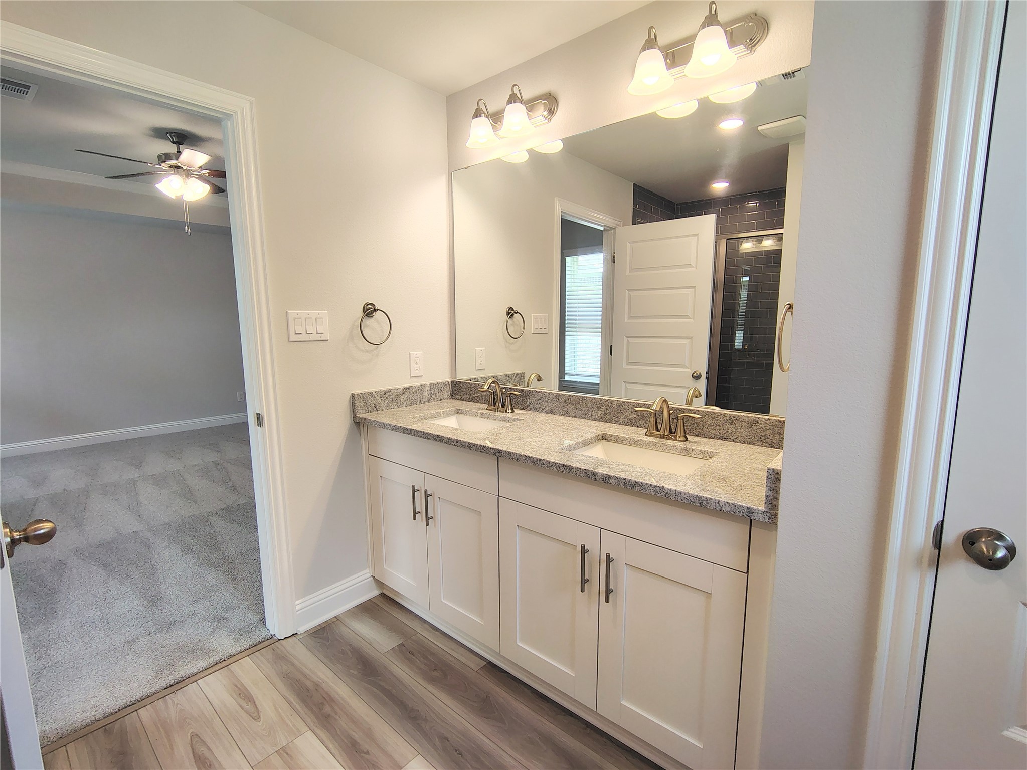 601 Greystone Lane Angleton, TX 77515 - Photo 16 of 31 a bathroom with a double vanity sink and mirror