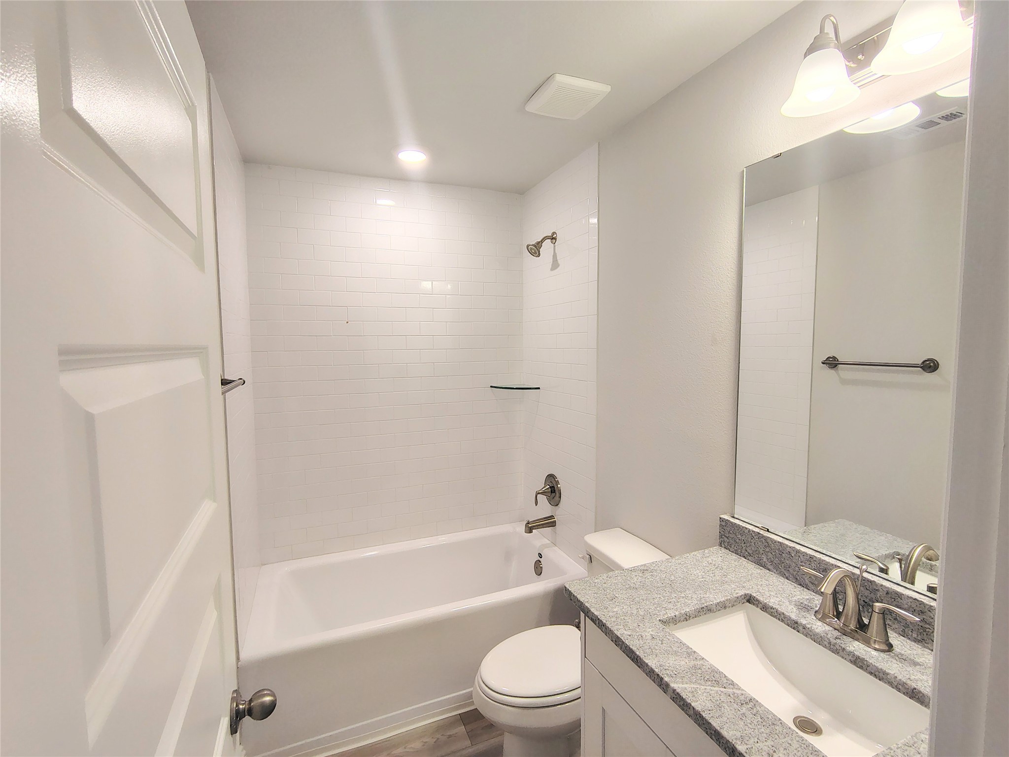 601 Greystone Lane Angleton, TX 77515 - Photo 25 of 31 a bathroom with a granite countertop sink toilet tub and shower