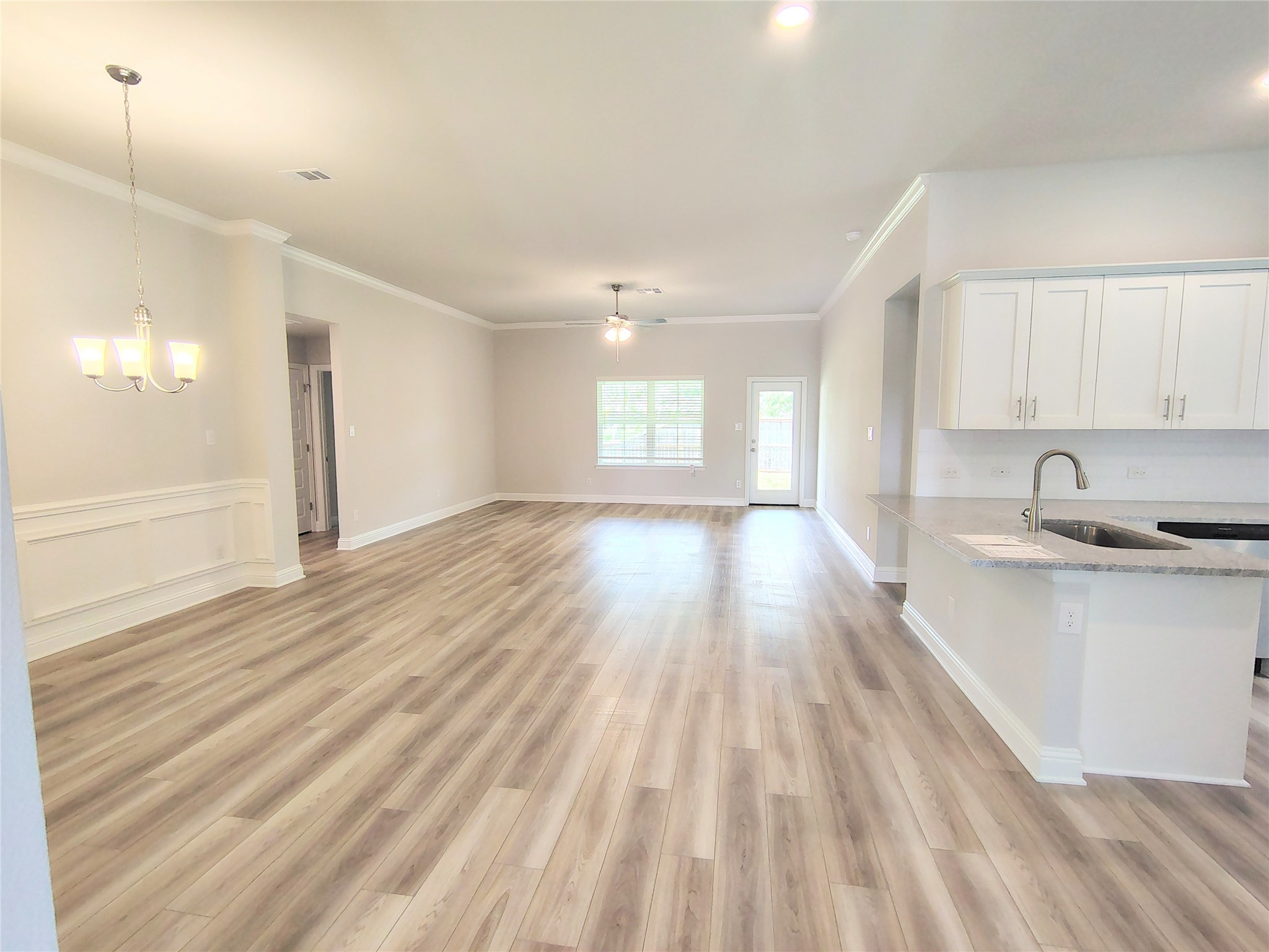 601 Greystone Lane Angleton, TX 77515 - Photo 6 of 31 a view of a kitchen with wooden floor and a sink