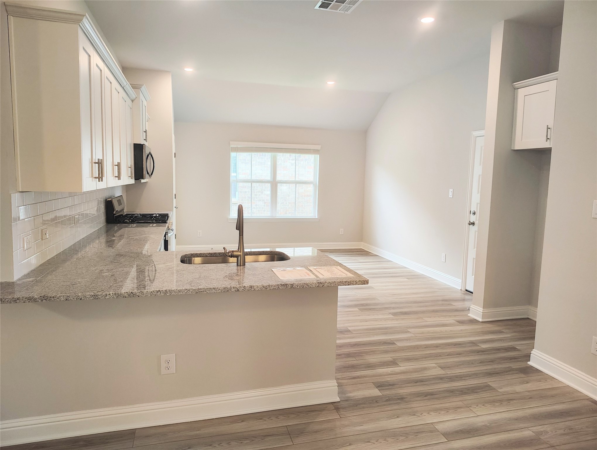 601 Greystone Lane Angleton, TX 77515 - Photo 10 of 31 a view of a kitchen counter space with wooden floor