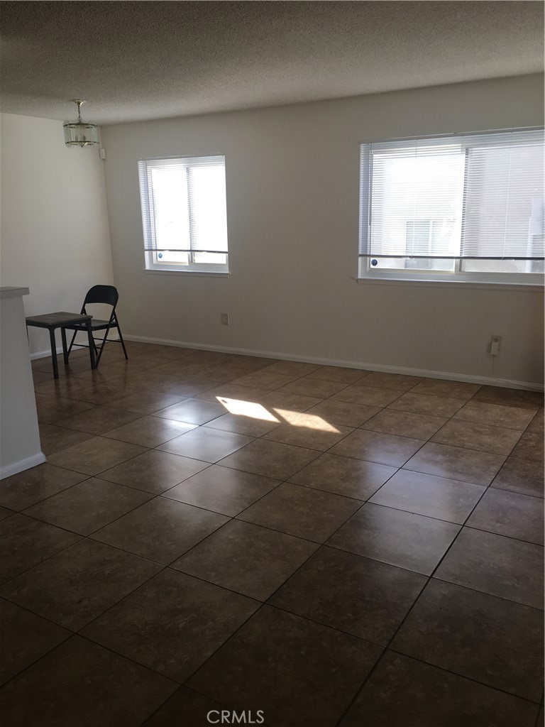 3545 20th Street Highland, CA 92346 - Photo 4 of 12 an empty room with windows and a fireplace