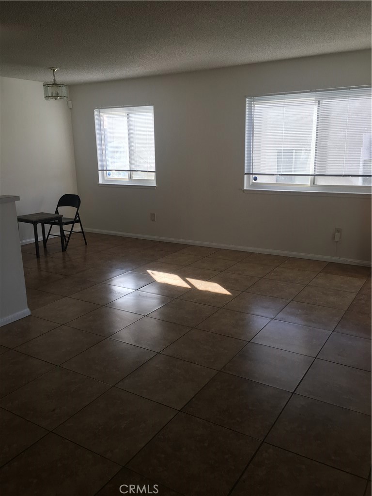 3545 20th Street Highland, CA 92346 - Photo 5 of 12 en empty room with windows and fireplace