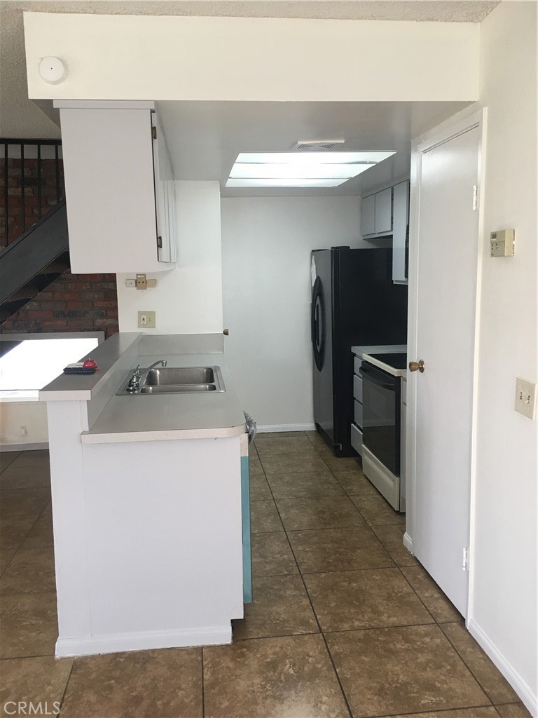 3545 20th Street Highland, CA 92346 - Photo 6 of 12 a utility room with cabinets washer and dryer