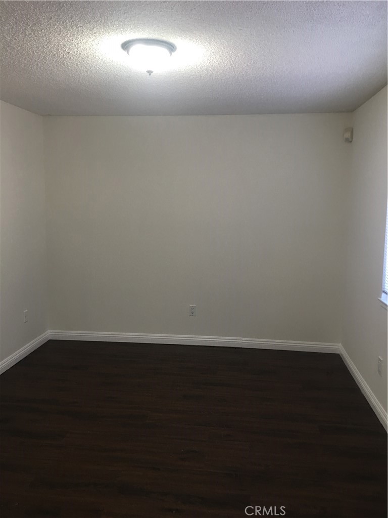 3545 20th Street Highland, CA 92346 - Photo 8 of 12 an empty room with wooden floor and windows