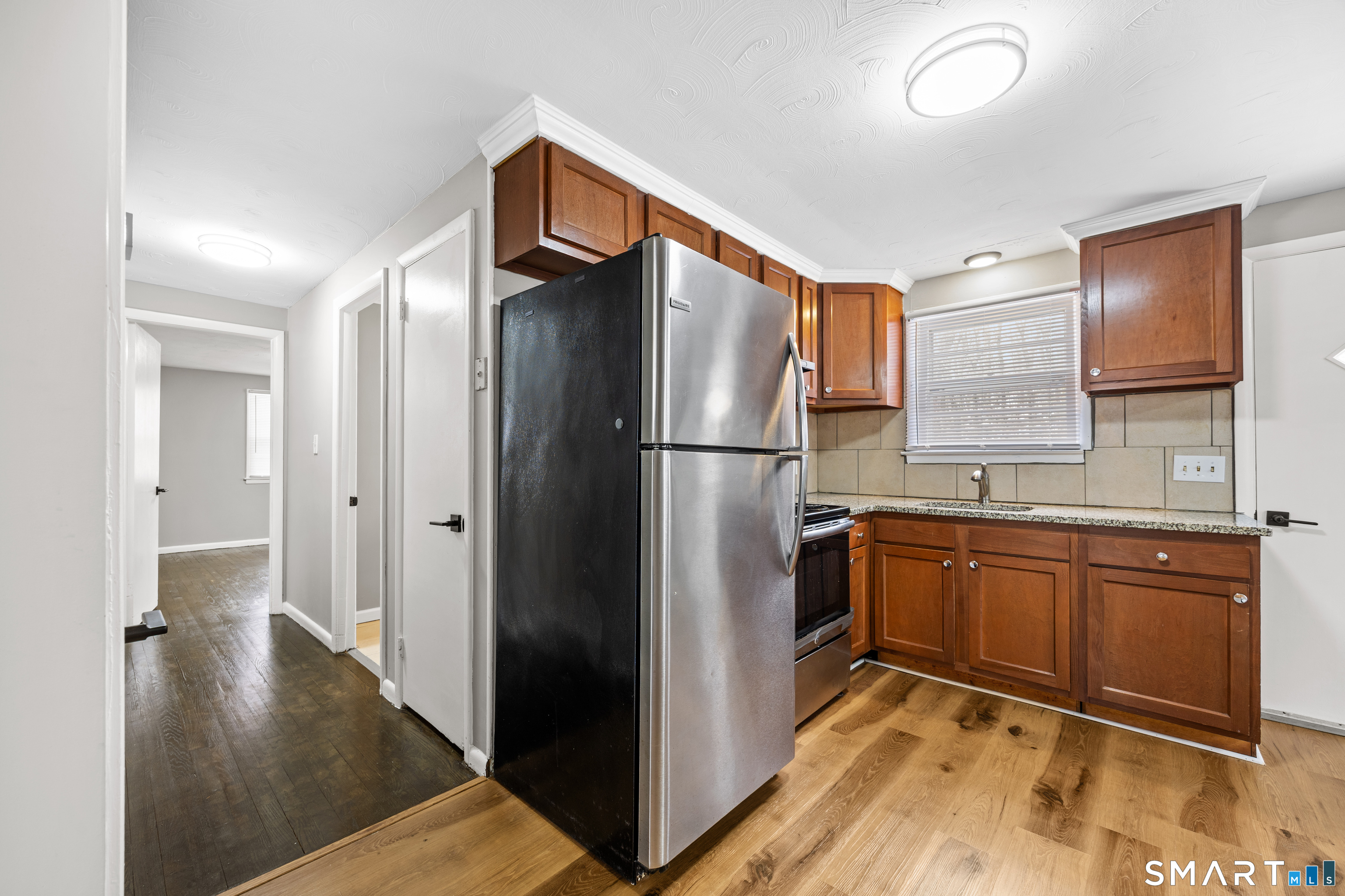 175 Devonwood Drive Waterbury, CT 06708 - Photo 12 of 30 a kitchen with stainless steel appliances granite countertop a refrigerator and a sink