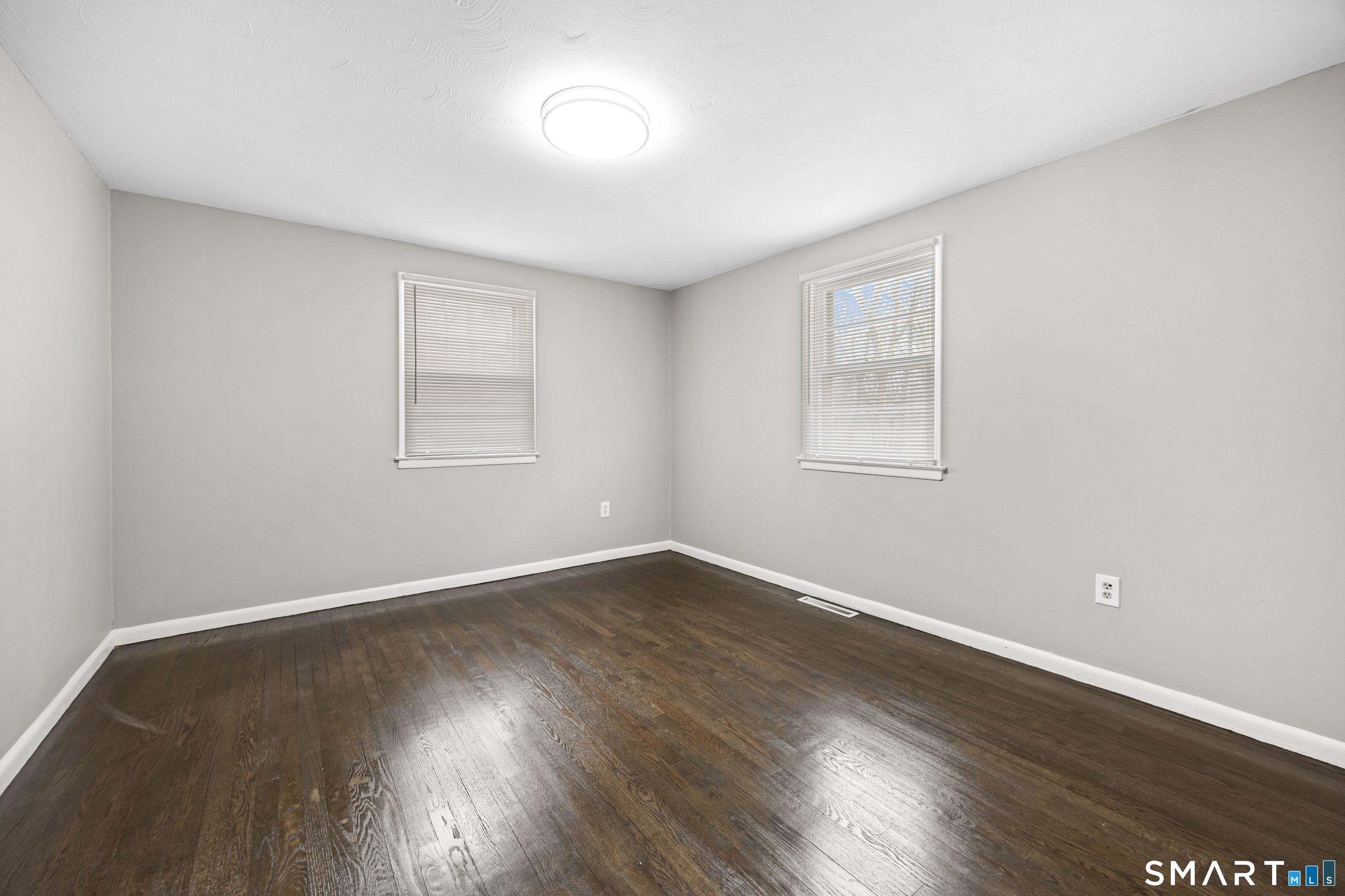 175 Devonwood Drive Waterbury, CT 06708 - Photo 14 of 30 an empty room with wooden floor and windows