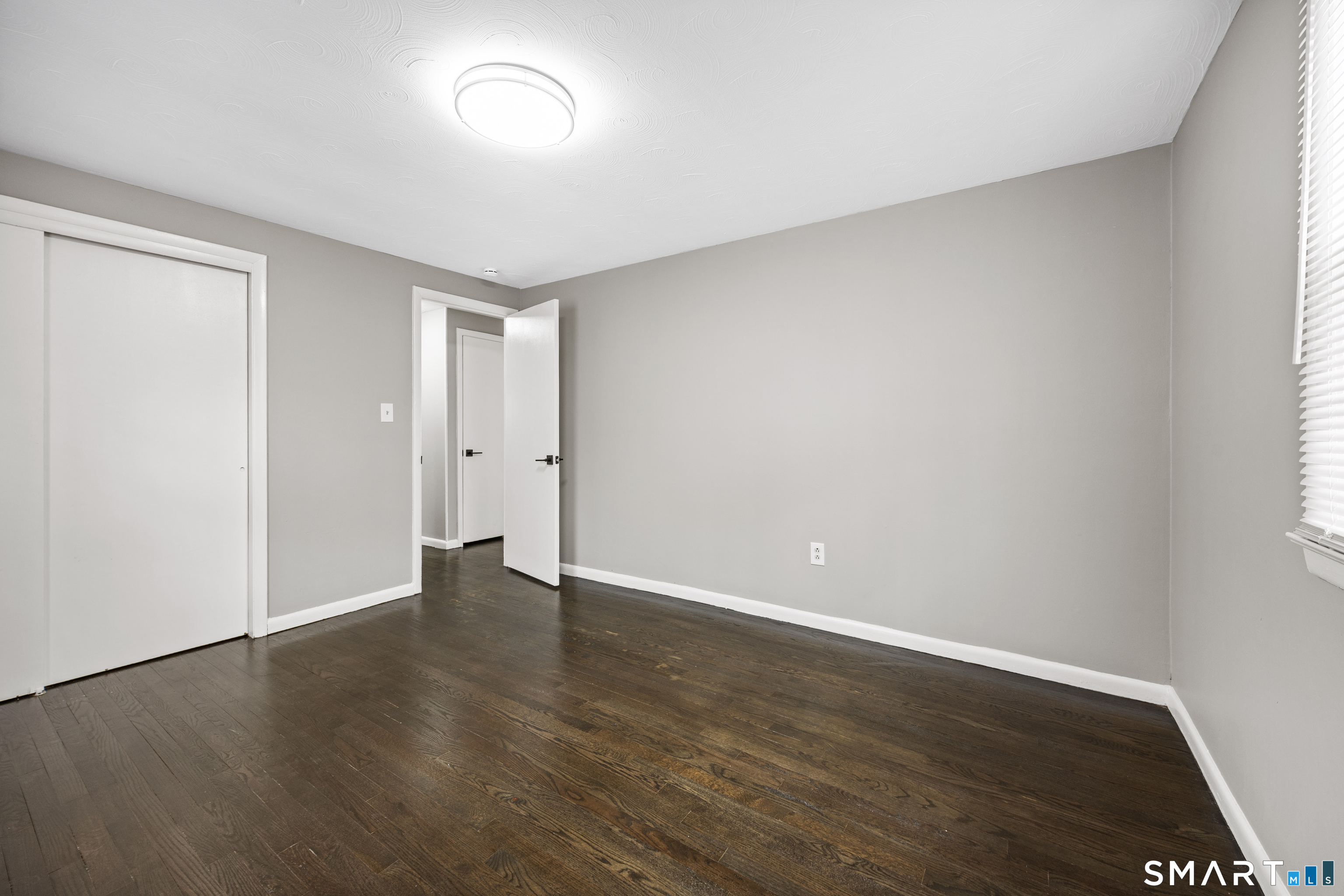 175 Devonwood Drive Waterbury, CT 06708 - Photo 16 of 30 a view of an empty room with wooden floor