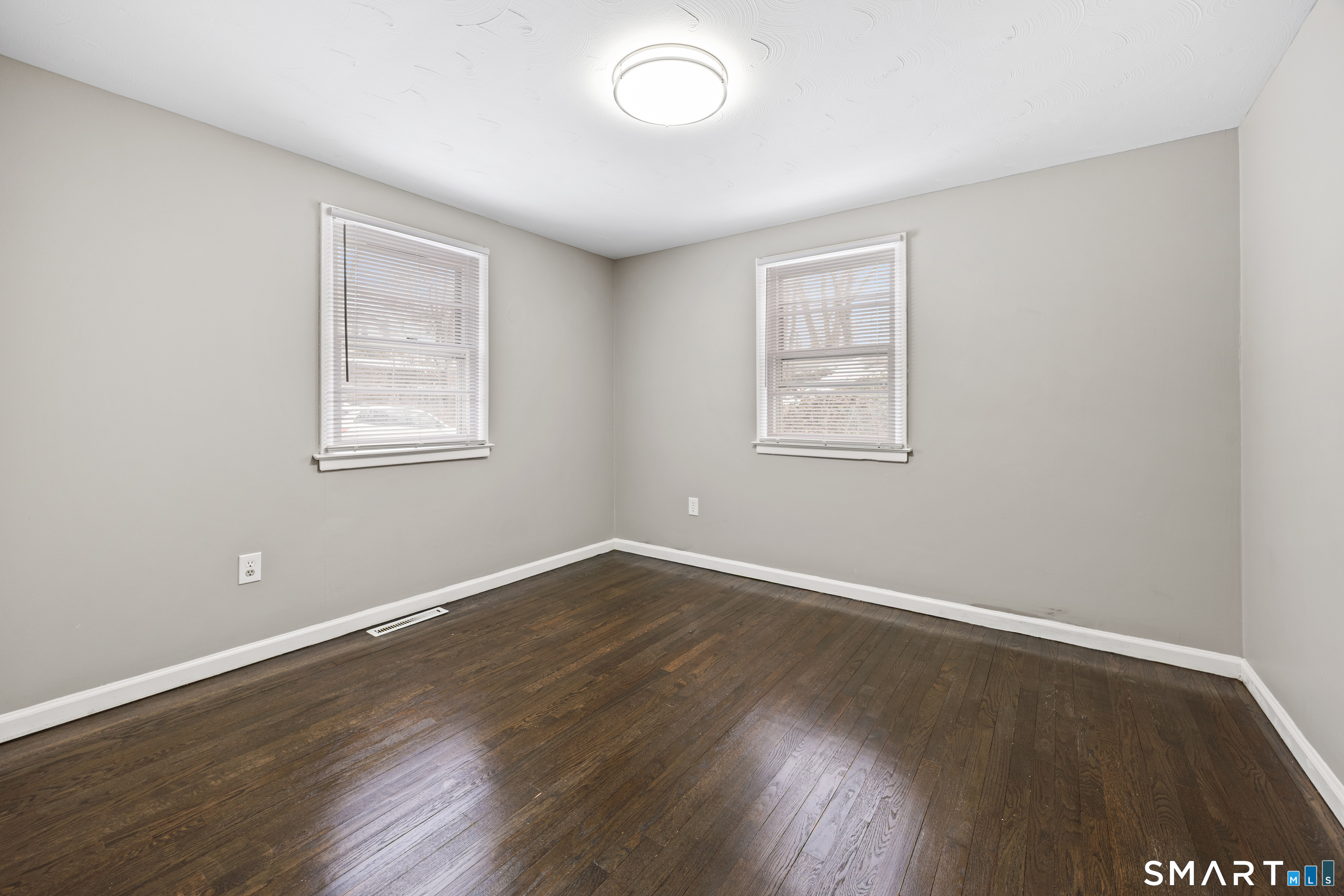 175 Devonwood Drive Waterbury, CT 06708 - Photo 17 of 30 an empty room with wooden floor and windows