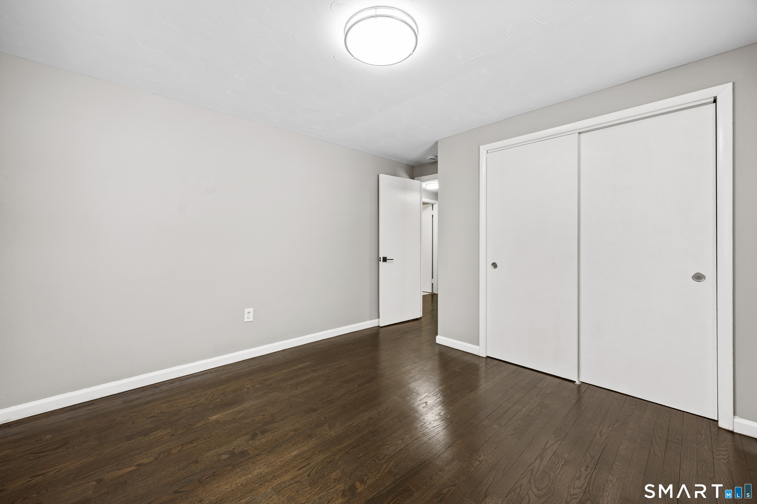 175 Devonwood Drive Waterbury, CT 06708 - Photo 19 of 30 a view of an empty room with wooden floor