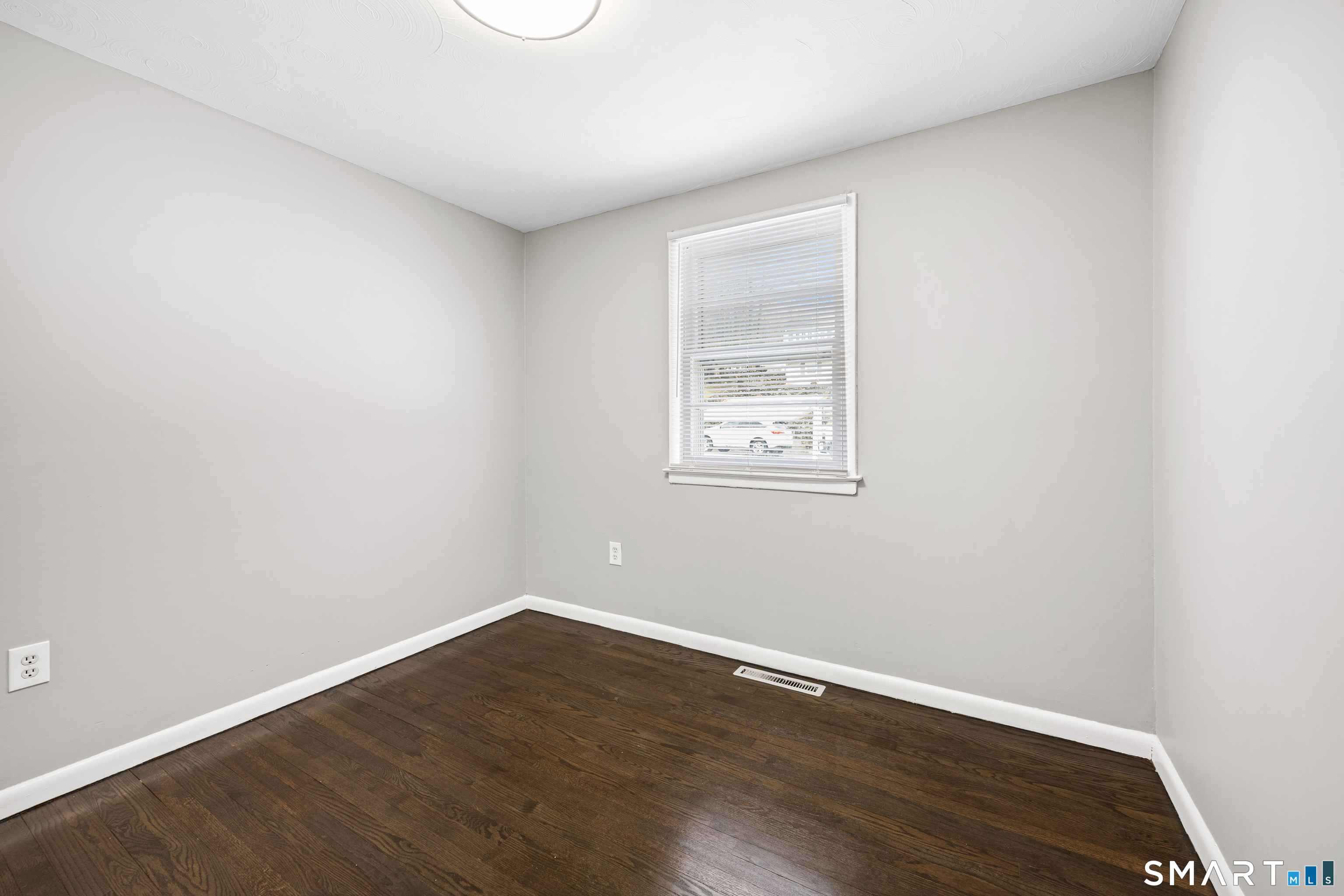175 Devonwood Drive Waterbury, CT 06708 - Photo 20 of 30 an empty room with wooden floor and windows
