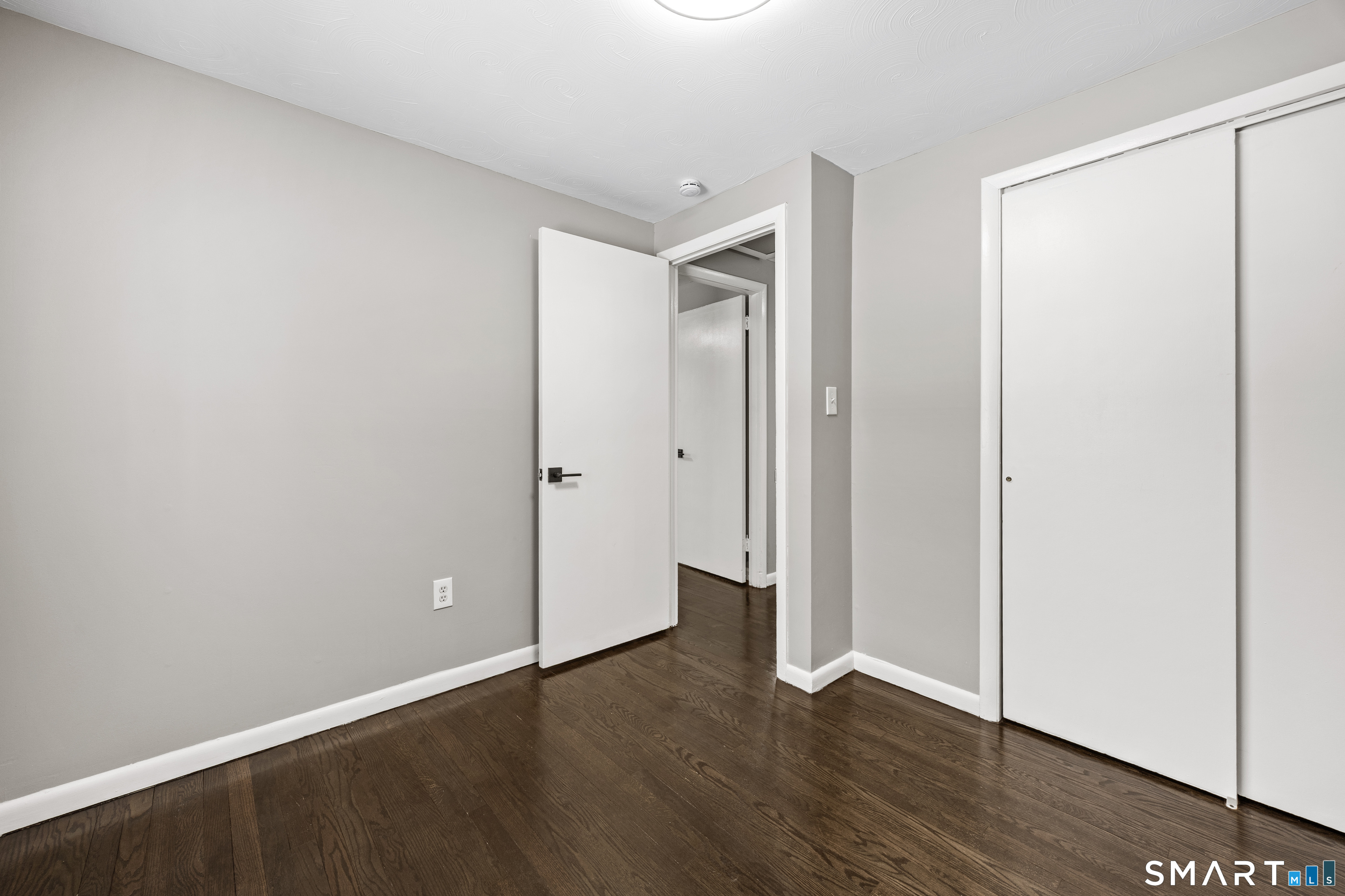 175 Devonwood Drive Waterbury, CT 06708 - Photo 22 of 30 an empty room with wooden floor